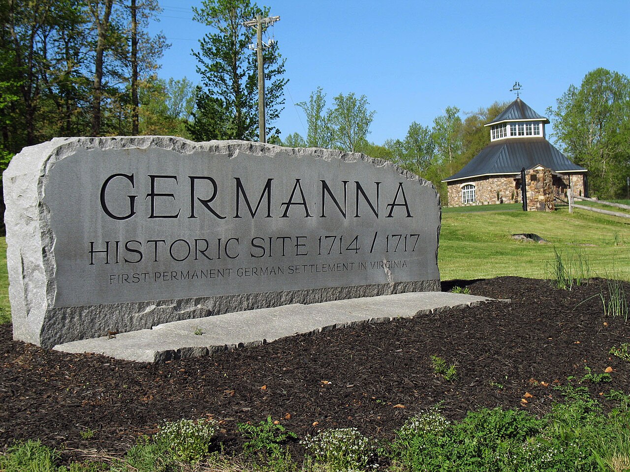 Stone Germanna sign with the visitor center behind it