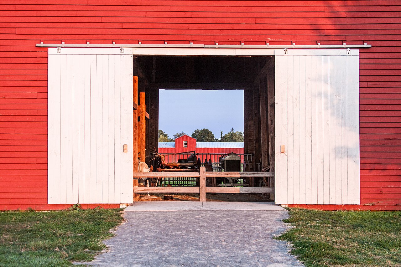 View through an open red barn at Kidwell Farm