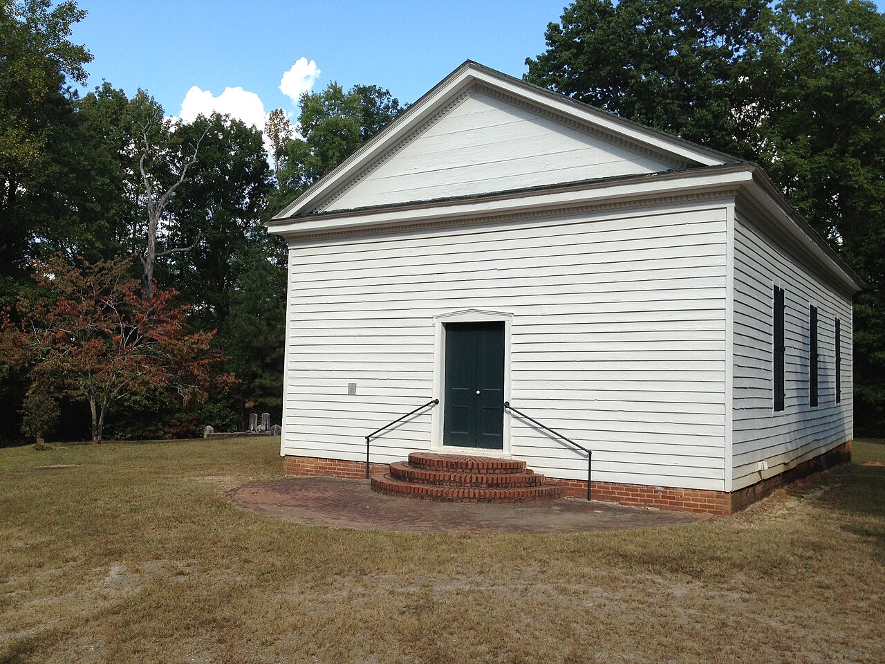 White wooden Sapony Church with brick foundation