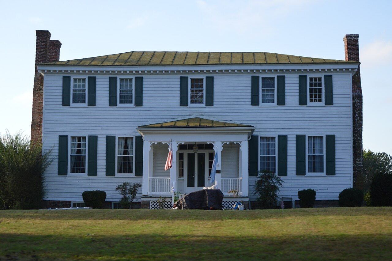 White facade and dark shutters of the Barrett-Chumney House