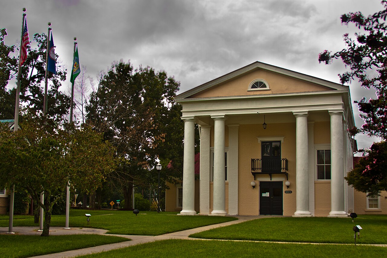 Columned Dinwiddie County courthouse beneath a cloudy sky
